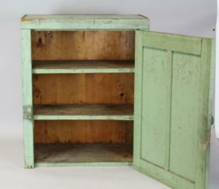 A 19TH C HANGING OR TABLE CUPBOARD IN APPLE GREEN PAINT PANEL DOOR 4