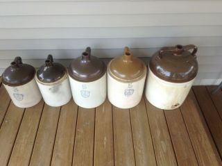 Two 5 Gallon wine jugs and two 3 gallon jugs,  and one 8 gallon jug.  Uhl pottery. 2
