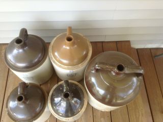 Two 5 Gallon wine jugs and two 3 gallon jugs,  and one 8 gallon jug.  Uhl pottery. 3