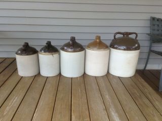 Two 5 Gallon wine jugs and two 3 gallon jugs,  and one 8 gallon jug.  Uhl pottery. 5