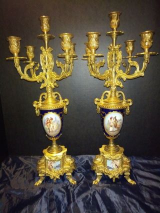 A Gilt Brass And Cobalt Porcelain Candelabras Clock Garniture