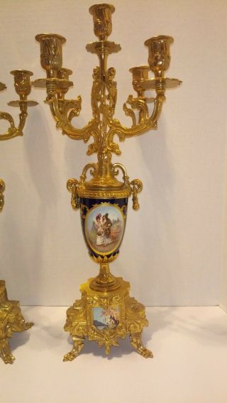 A GILT BRASS AND COBALT PORCELAIN CANDELABRAS CLOCK GARNITURE 4