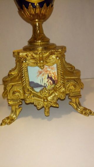 A GILT BRASS AND COBALT PORCELAIN CANDELABRAS CLOCK GARNITURE 9