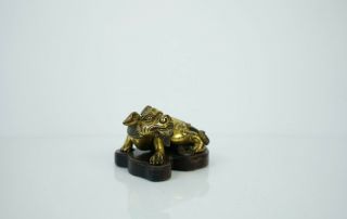 A Gilt Bronze Figure of a Seated Mystical Beast,  with a wooden stand 3