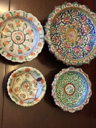 Stack of antique Chinese hand painted multicolored pottery dishes. 2