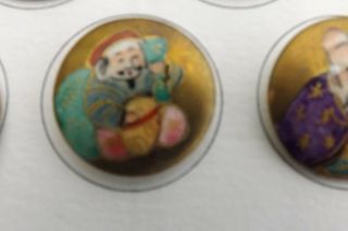 A CARD OF SEVEN FINE SATSUMA BUTTONS JAPANESE GODS 2.  5cms 2