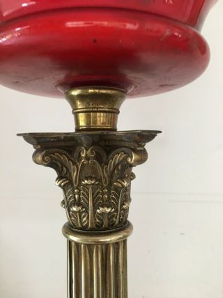 large oil lamp with blood red glass fount,  brass corinthian base and red shade 2