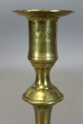 AN EARLY 18TH C ENGLISH QA BRASS CANDLESTICK BALUSTER FORM GREAT PETAL BASE 11