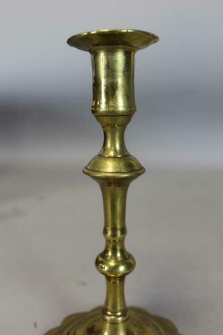 AN EARLY 18TH C ENGLISH QA BRASS CANDLESTICK BALUSTER FORM GREAT PETAL BASE 9