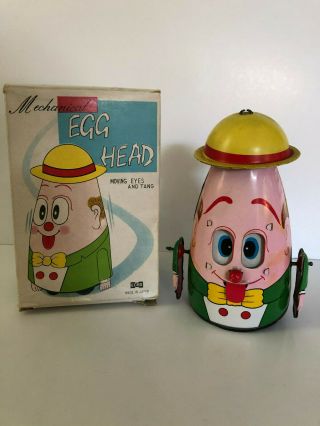 Japan Tin Mechanical Wind Up Egg Head Moving Eyes And Tang