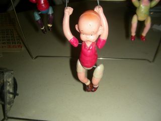 antique celluloid trapeze artist ' s swing toy 2