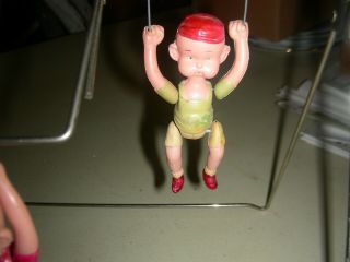 antique celluloid trapeze artist ' s swing toy 4
