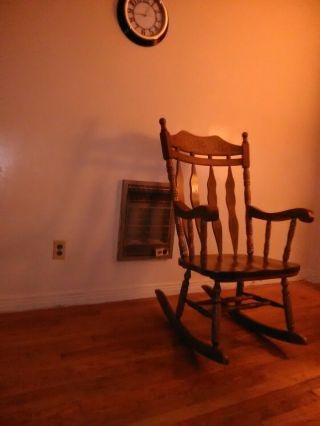 Solid wood rocking chair big and bulky,  brown color. 2