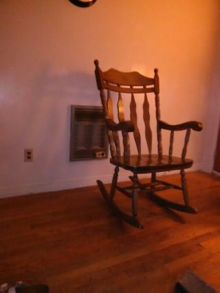 Solid wood rocking chair big and bulky,  brown color. 3