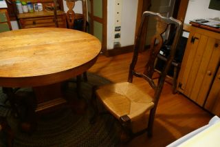 Antique oak pedestal dining table and B.  Altman rushed dining chairs 2