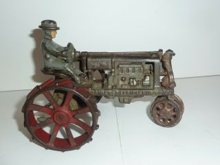 CAST IRON INTERATIONAL FARM TRACTOR.  ALL CAST IRON 6 - 1/2 INCH 2