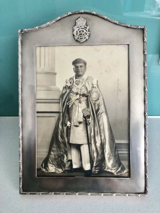 A Vintage Silver Picture Frame With A Crest In The Centre