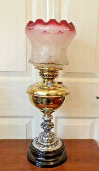A Victorian Veritas Oil Lamp Stunning Item With Cranberry Rimmed Glass Shade