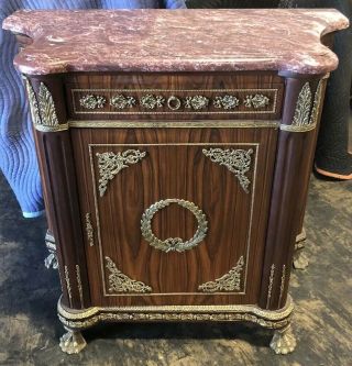 Antique French Style Mable Top Cabinet With Bronze Accents.