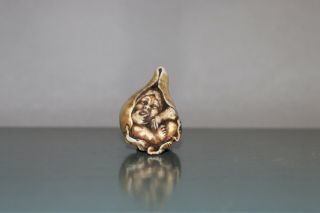 Antique Japanese Netsuke of Momotaro sitting in a peach. 3