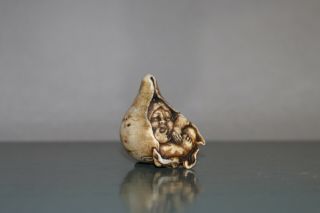 Antique Japanese Netsuke of Momotaro sitting in a peach. 4