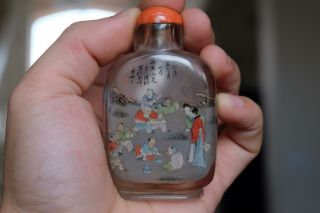AN INSIDE - PAINTED CRYSTAL SNUFF BOTTLE.  WITH CORAL TOP. 10