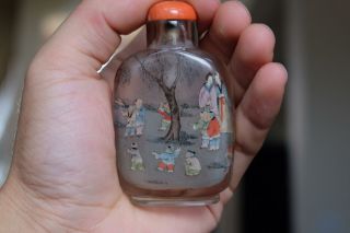 AN INSIDE - PAINTED CRYSTAL SNUFF BOTTLE.  WITH CORAL TOP. 11