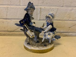 Vintage German Volkstedt Porcelain Blue White Gold Figurine Boy & Girl On Seesaw