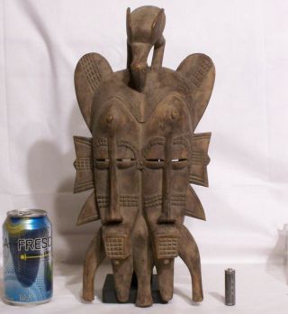 20th Century Senufo Carved Wooden Kpelie Double Faced Mask On Stand