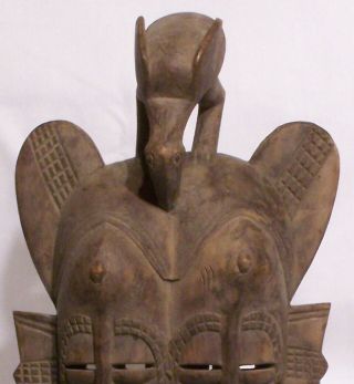 20th Century Senufo carved wooden Kpelie Double faced mask on stand 2