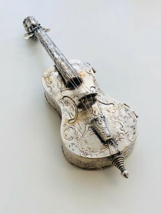 A Silver Model Of A Violin Embossed With Figures And Scrolls German