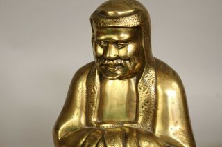 A Chinese bronze gilt figure of Bodhidharma Daruma Arhat,  wood stand 19th/20thc 12