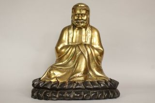A Chinese bronze gilt figure of Bodhidharma Daruma Arhat,  wood stand 19th/20thc 2