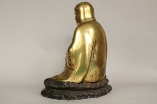A Chinese bronze gilt figure of Bodhidharma Daruma Arhat,  wood stand 19th/20thc 5