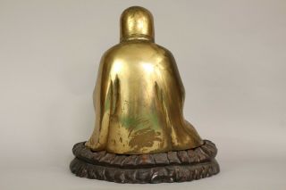 A Chinese bronze gilt figure of Bodhidharma Daruma Arhat,  wood stand 19th/20thc 6