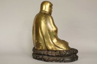 A Chinese bronze gilt figure of Bodhidharma Daruma Arhat,  wood stand 19th/20thc 7