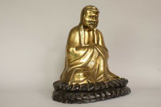 A Chinese bronze gilt figure of Bodhidharma Daruma Arhat,  wood stand 19th/20thc 9