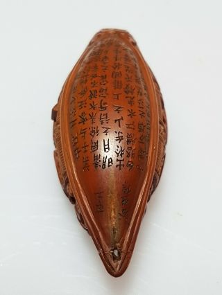 A Qing Dynasty Inscribed Olive Stone Carving Of A Boat Signed GUSHENG 1864. 12