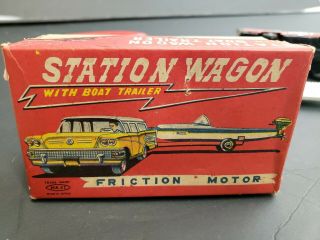 Vintage tin toy station wagon with boat friction Japan 9