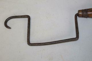 AN EXTREMELY RARE 18TH C WROUGHT IRON AND WOOD HANDLE ROPE WINDER IN OLD SURFACE 9