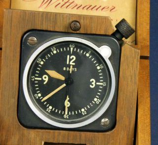 B 815.  WITTNAUER 8 DAY MILITARY CLOCK IN THE BOX.  WATCH IS NOT IN RUN 5