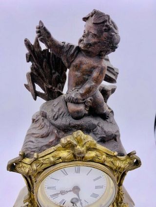 Antique Mantle clock with Cherubic figure,  gilt and marble surround.  Poss French 2