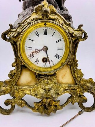 Antique Mantle clock with Cherubic figure,  gilt and marble surround.  Poss French 3