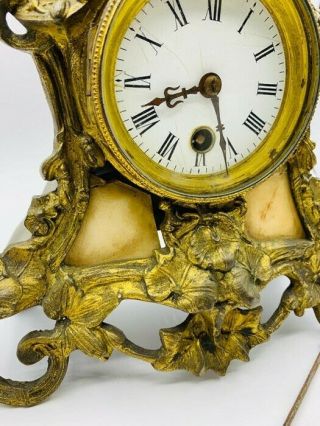 Antique Mantle clock with Cherubic figure,  gilt and marble surround.  Poss French 4