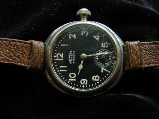 EARLY TRENCH INGERSOLL WRISTWATCH,  RADIOLITE.  BLACK DIAL.  LEATHER BAND. 3