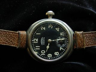 EARLY TRENCH INGERSOLL WRISTWATCH,  RADIOLITE.  BLACK DIAL.  LEATHER BAND. 4