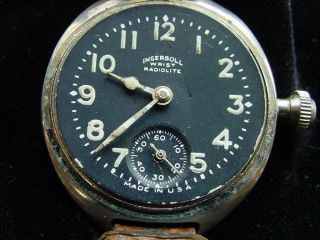 EARLY TRENCH INGERSOLL WRISTWATCH,  RADIOLITE.  BLACK DIAL.  LEATHER BAND. 8