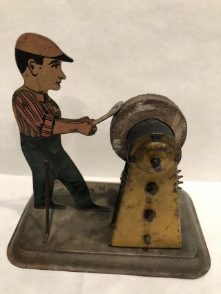 1920s Girard Key Wind Tin Litho Man With Grinding Wheel Toy