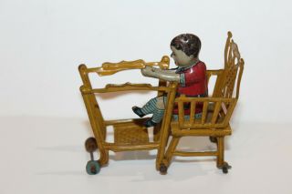 EARLY 1900 ' s GERMAN TIN LITHO CHILD IN HIGH CHAIR PENNY TOY 10