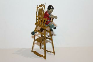 EARLY 1900 ' s GERMAN TIN LITHO CHILD IN HIGH CHAIR PENNY TOY 12